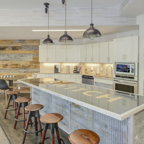 a kitchen with a bar stools and a bar stool