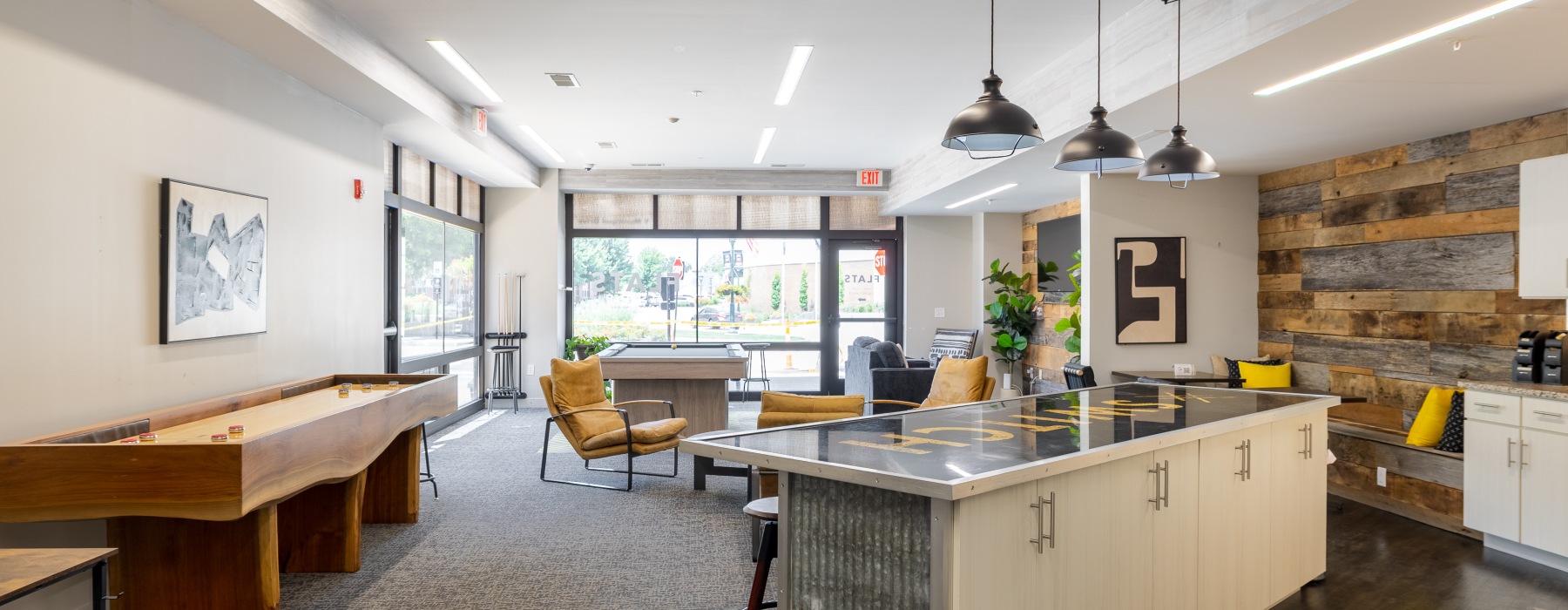 a kitchen with a bar stools and a bar stool