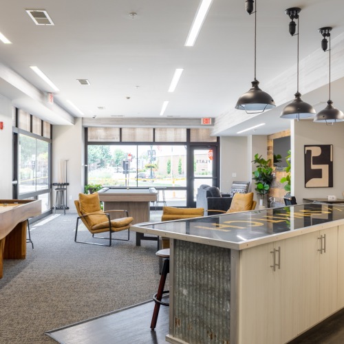 a kitchen with a bar stools and a bar stool