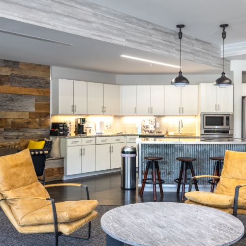 Clubhouse with yellow chairs and a kitchen