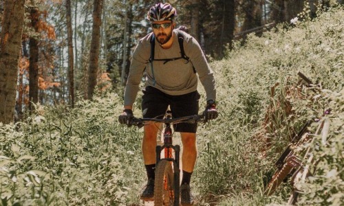 man riding a bike on a trail in the woods