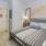 a bedroom with a bed and pictures on the wall