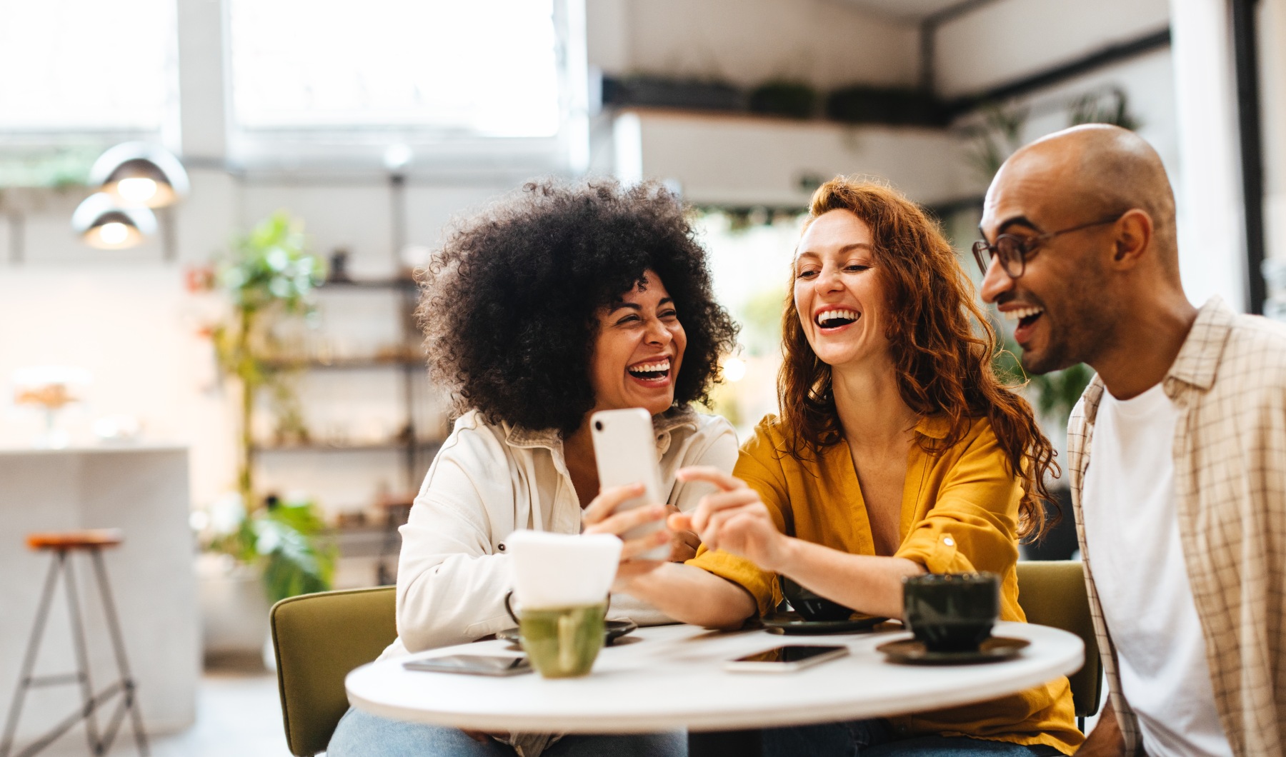 Group of people laughing around a table