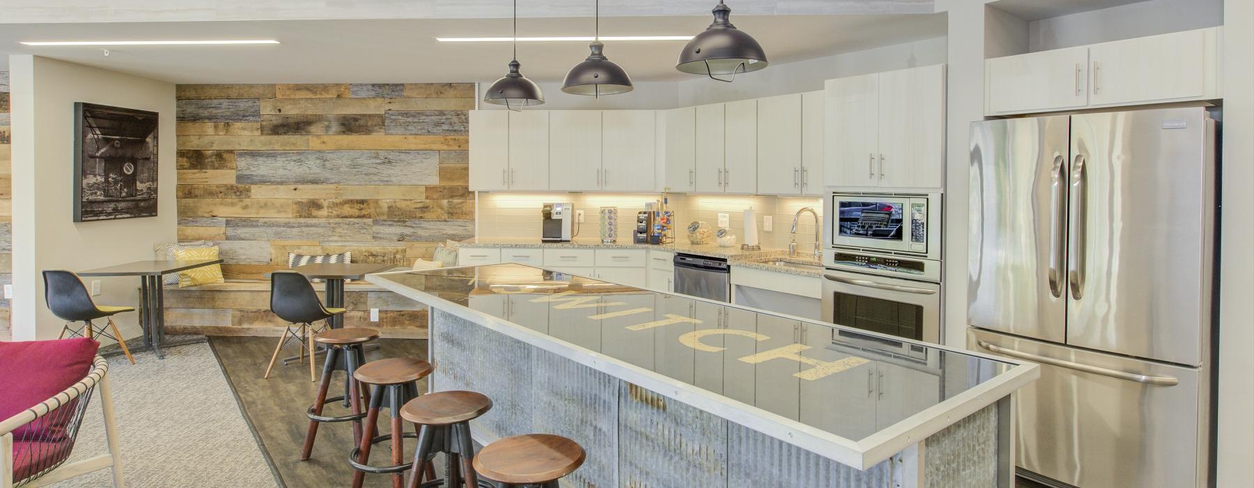 a kitchen with a bar stools and a bar stool